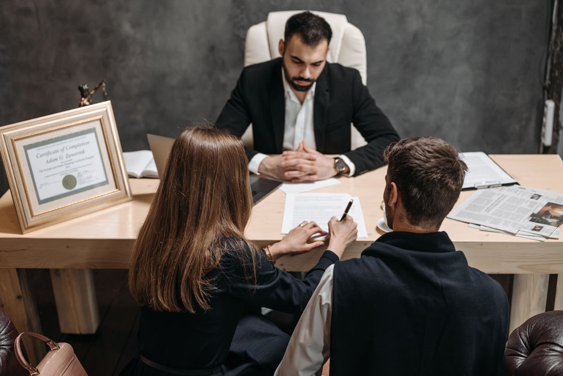 Lawyer reviewing documents with clients in a bright office