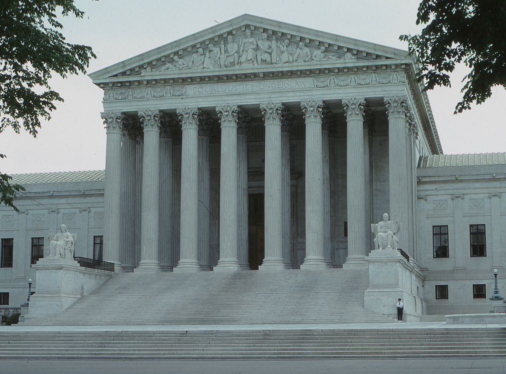 Classical courthouse columns against a clear sky