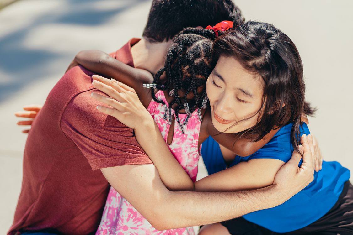 Family sharing a heartfelt hug outdoors